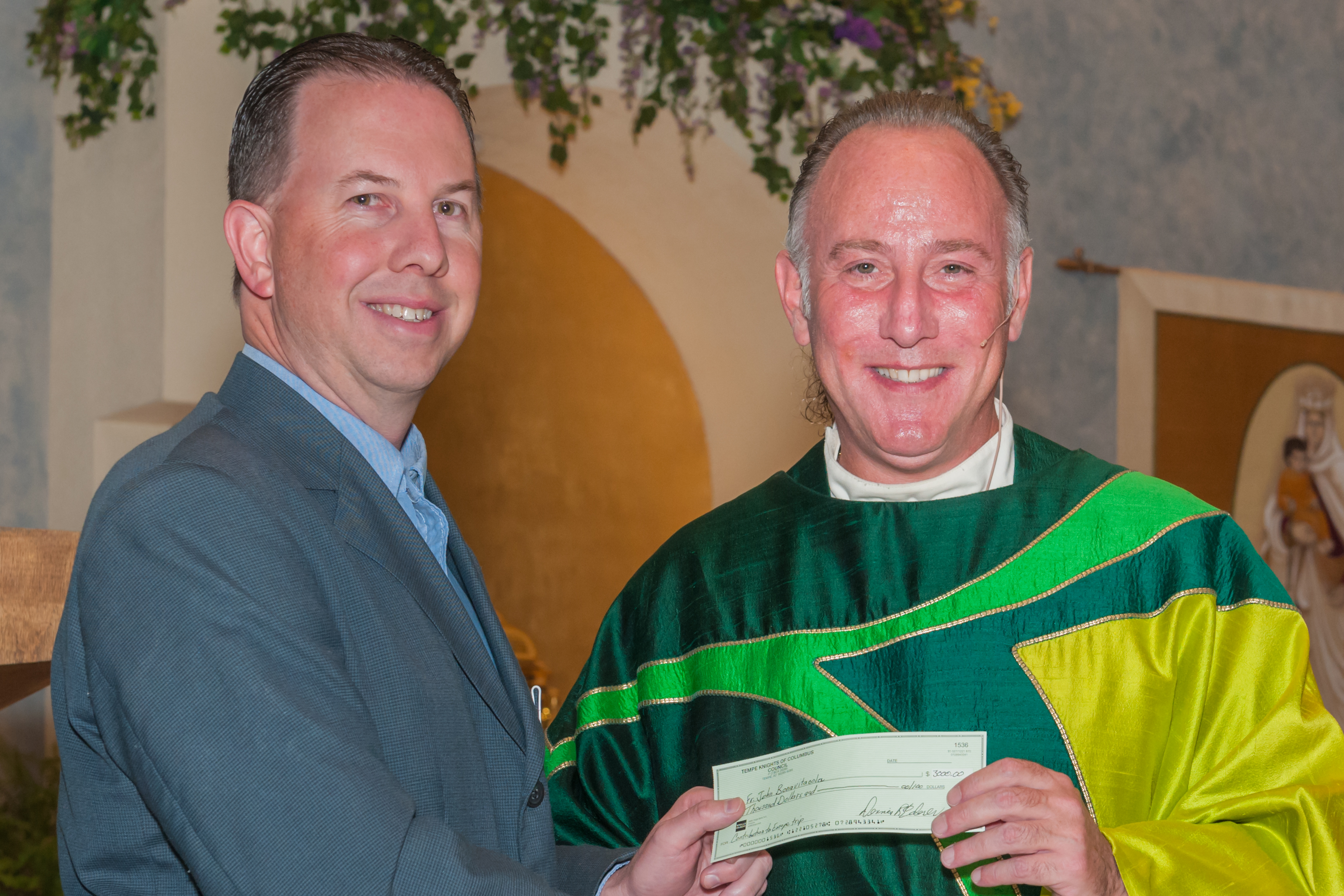 Tom G presenting check to Fr. John